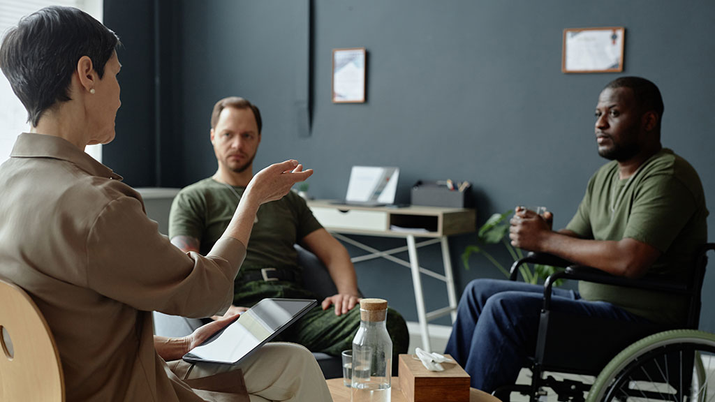 Veterans in office with therapist