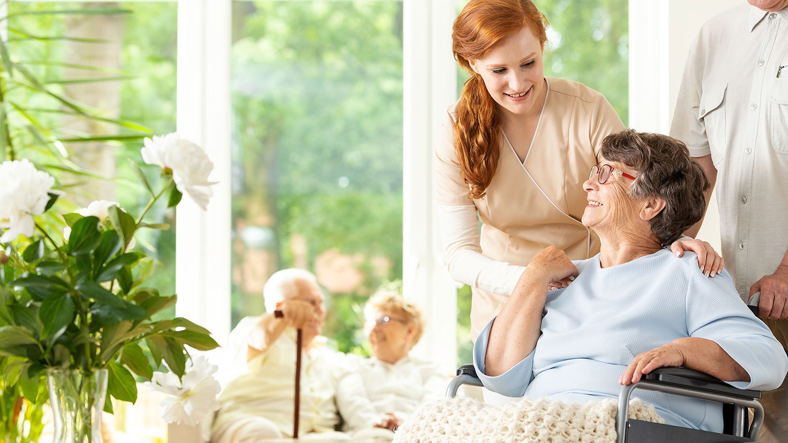 Caregiver assisting widow in assisted living