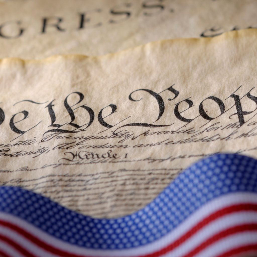 U.S. Constitution text with an American flag